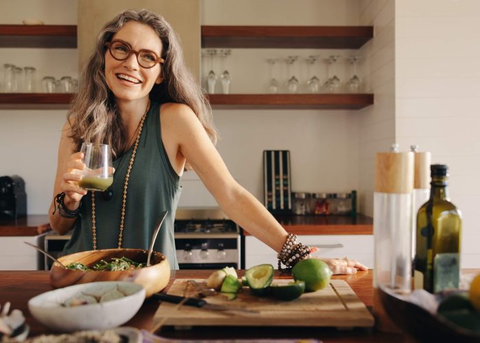 A smiling woman standing in a kitchen