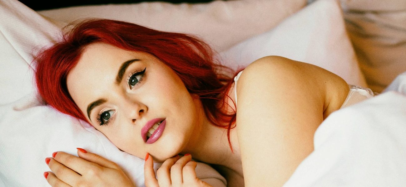 A woman lying bed under a duvet