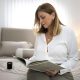 A woman reading a book on a bed