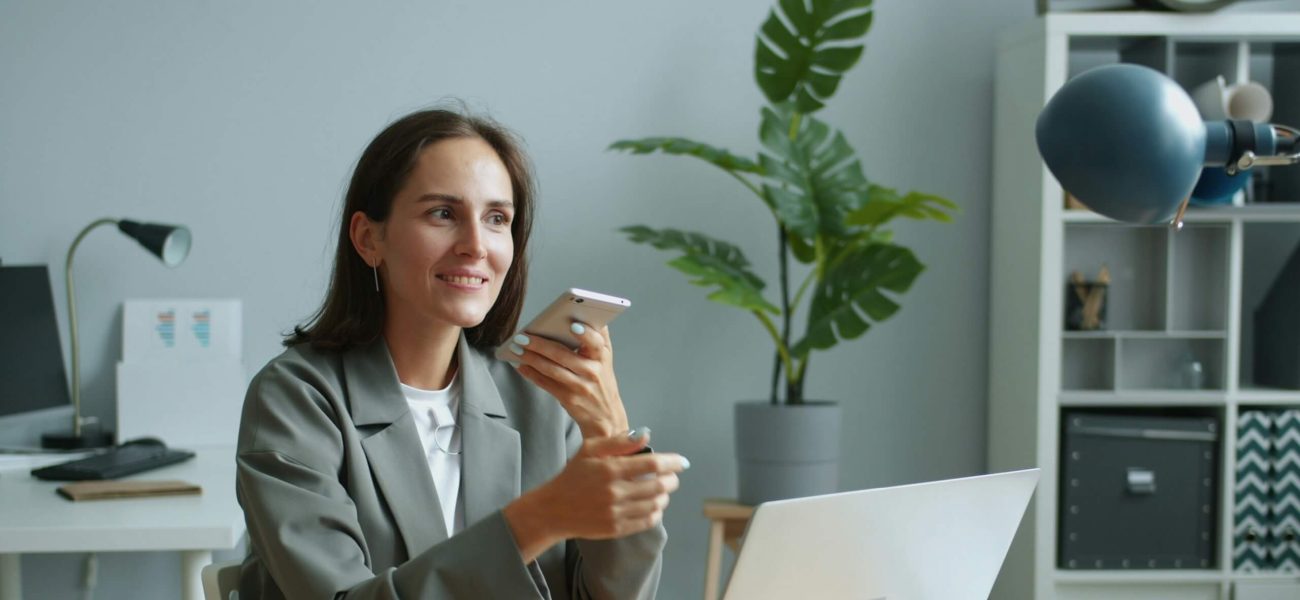 A woman in an office speaking on the phone