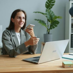A woman in an office speaking on the phone