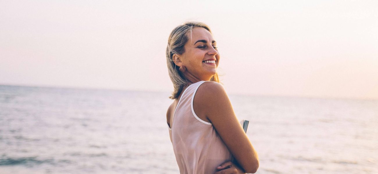 A woman smiling on the beach