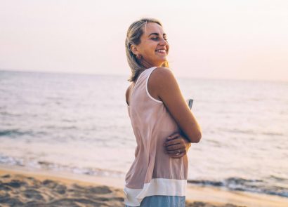A woman smiling on the beach