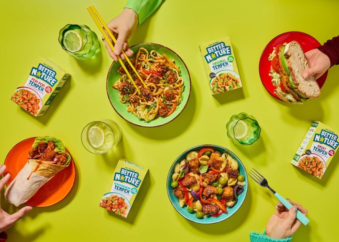 Hands reaching for bowls of Better Nature's tempeh range