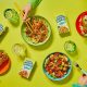 Hands reaching for bowls of Better Nature's tempeh range
