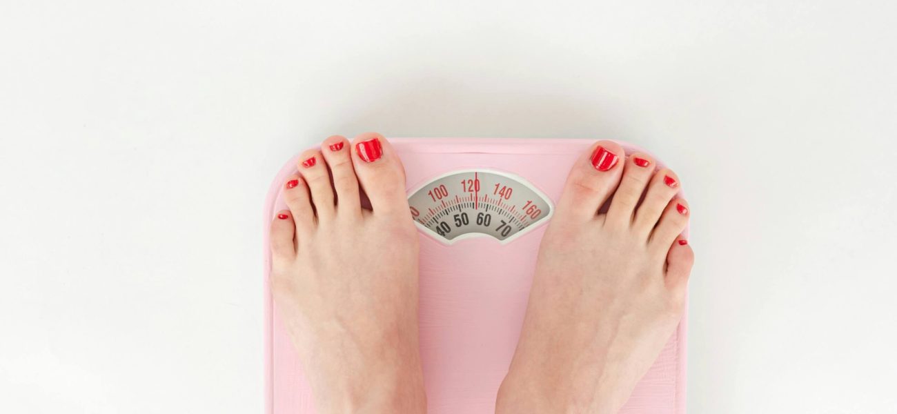 A woman's feet standing on a set of scales