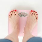 A woman's feet standing on a set of scales