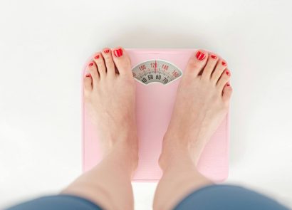A woman's feet standing on a set of scales