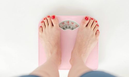 A woman's feet standing on a set of scales