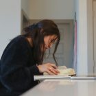 A woman studying on a laptop at home