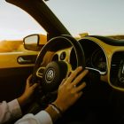 A woman driving a Volkswagen car