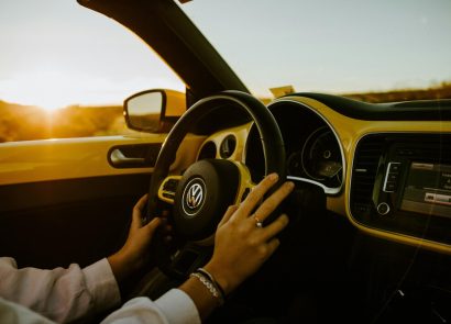 A woman driving a Volkswagen car