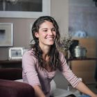 A happy woman sitting in a cosy living room