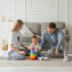 Two parents playing with their baby in a living room