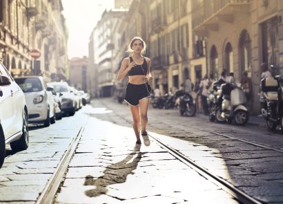 A woman running down a city street