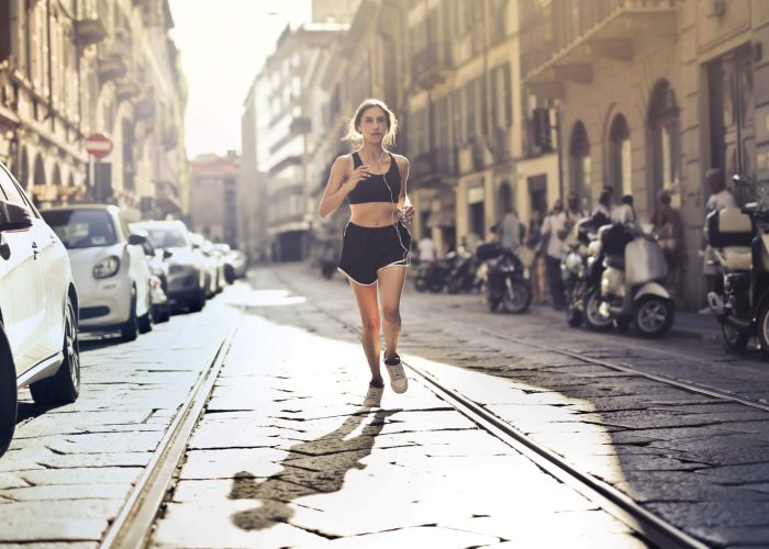 A woman running down a city street