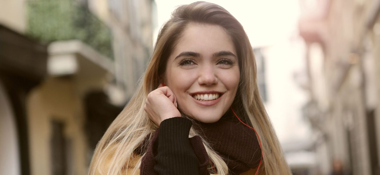 A woman on a city street smiling