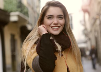 A woman on a city street smiling