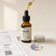A bottle of CBD oil alongside a certificate of authenticity