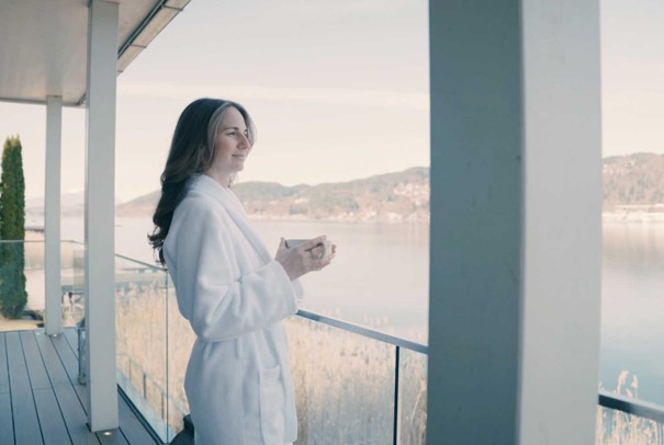A woman standing on a balcony at the Original Mayr Medical Resort