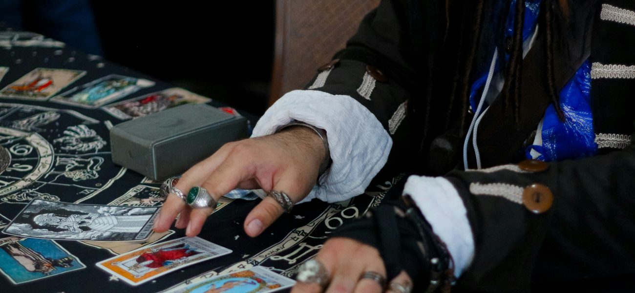 A man laying out tarot cards on a table