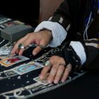 A man laying out tarot cards on a table