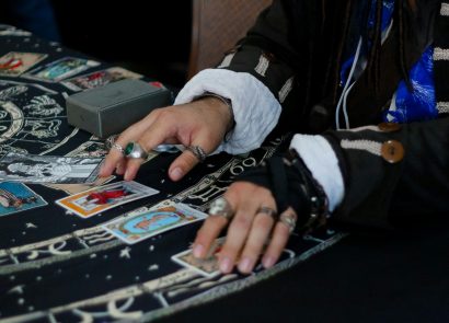 A man laying out tarot cards on a table