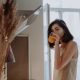 A woman drinking from a glass in the morning