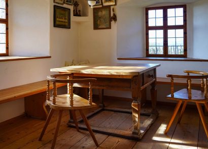 A rustic farmhouse dining room with table and chairs
