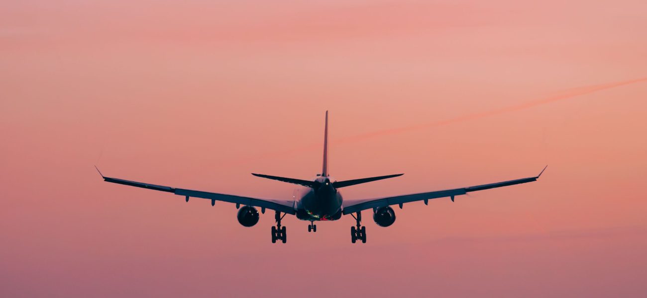 An airliner landing at sunset