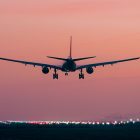 An airliner landing at sunset