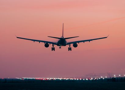 An airliner landing at sunset