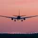An airliner landing at sunset
