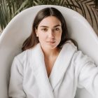 A woman in a spa robe lying in a bathtub