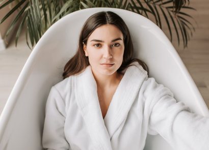 A woman in a spa robe lying in a bathtub