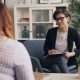 A woman sitting speaking to a female counsellor