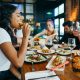 A group of men and women eating together in a restaurant