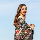 A woman wear a silk shawl outdoors