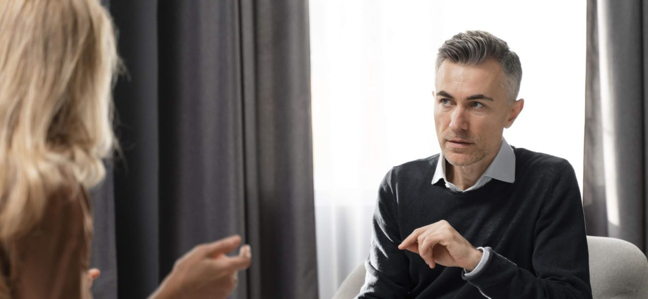 A therapist speaking with a client in an office
