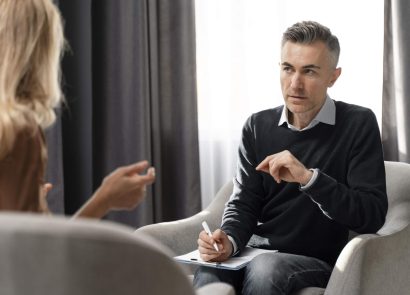 A therapist speaking with a client in an office