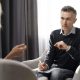 A therapist speaking with a client in an office